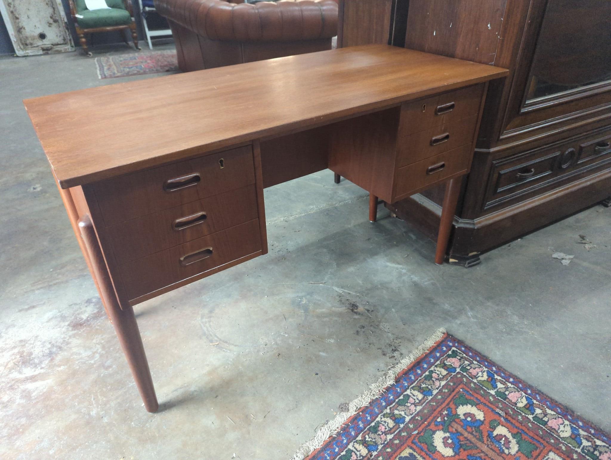 A mid century Danish teak kneehole dressing table of rectangular concave form, width 116cm, depth 55cm, height 72cm